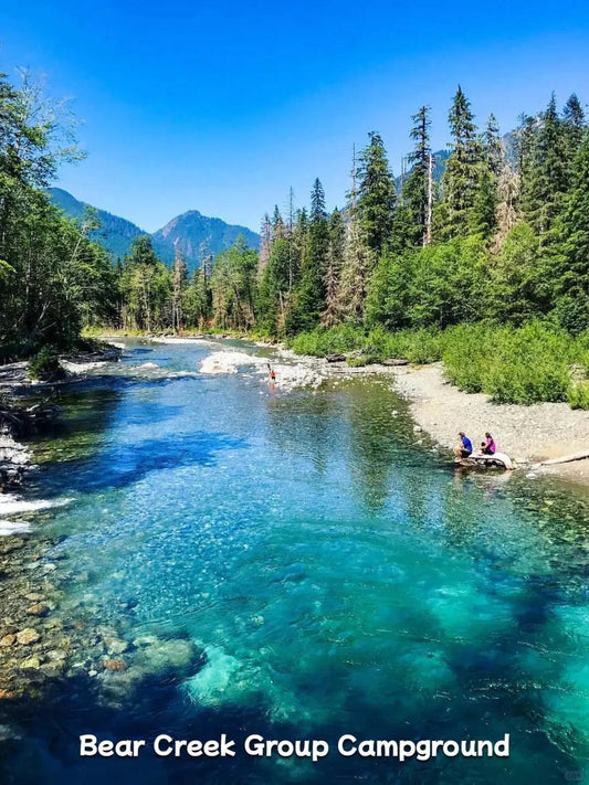 Crystal clear turquoise river at a campground near Mount Rainier in the forest.