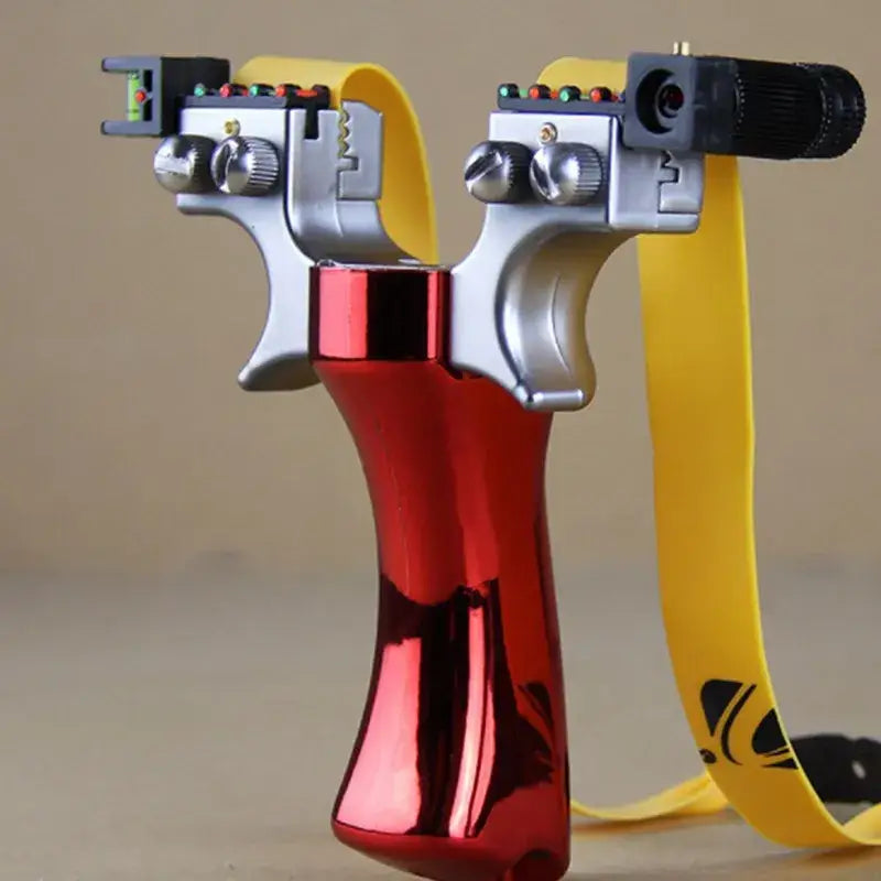 Metallic red laser sighted slingshot with dual prongs and yellow rubber band ┃TFGOGOGO